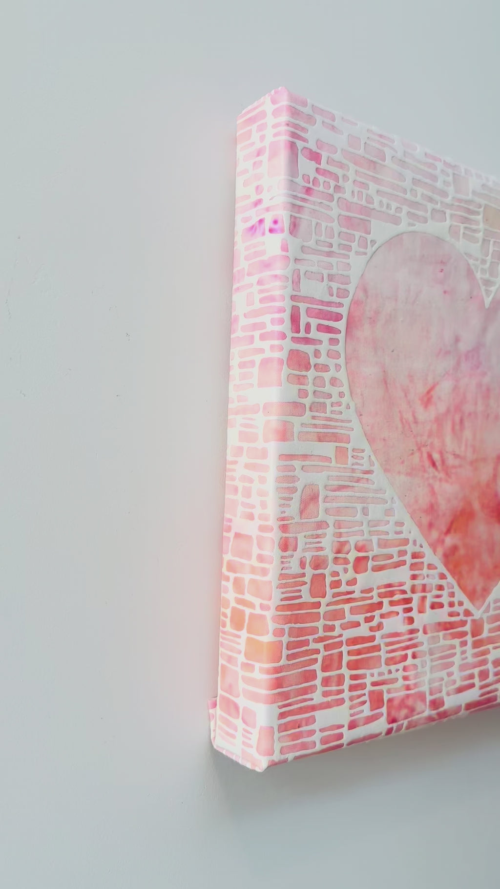 Heart shaped artwork with a white, pink, and orange gradient