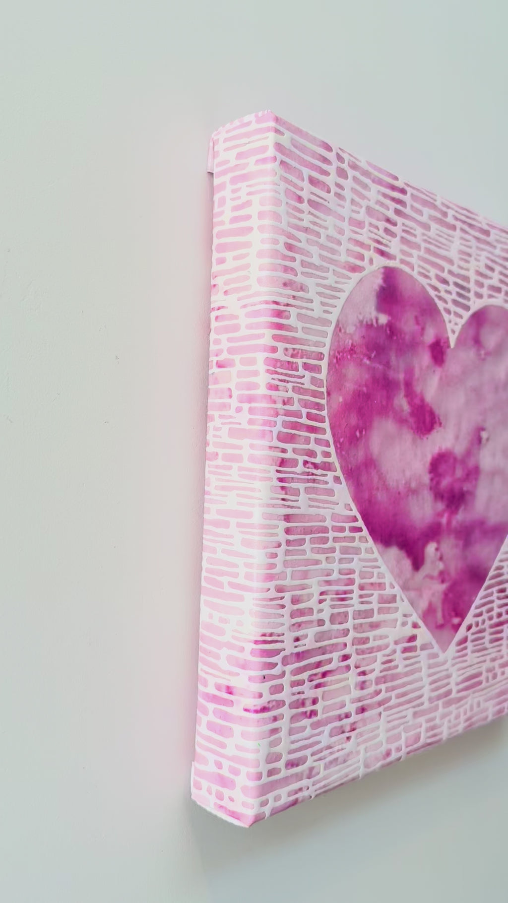 Heart shaped artwork with a white, pink, and magenta gradient
