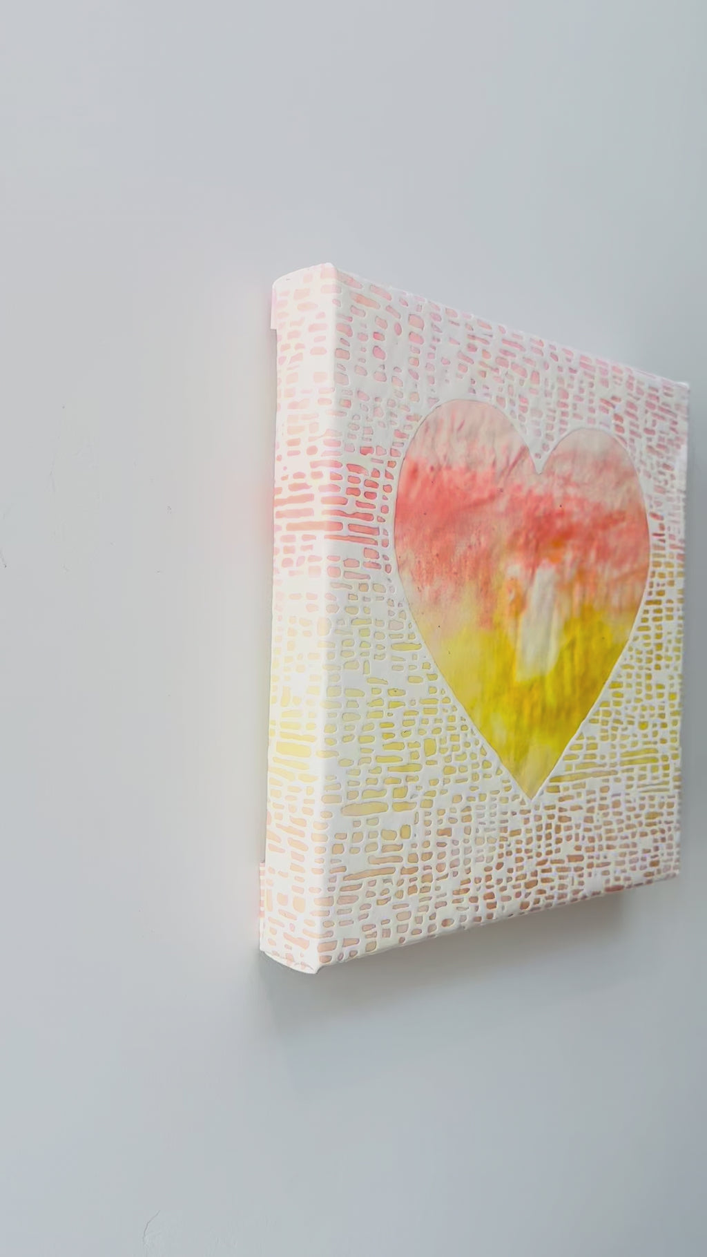 Heart shaped artwork with a yellow, white,  and orange gradient.