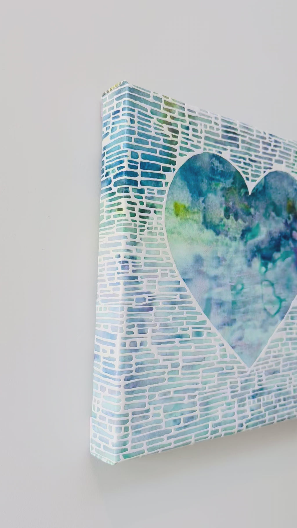 Heart shaped artwork with a white, blue, green, and yellow gradient