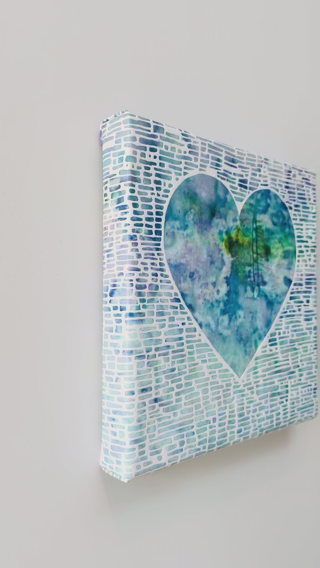 Heart shaped artwork with a white, blue, green, and yellow gradient