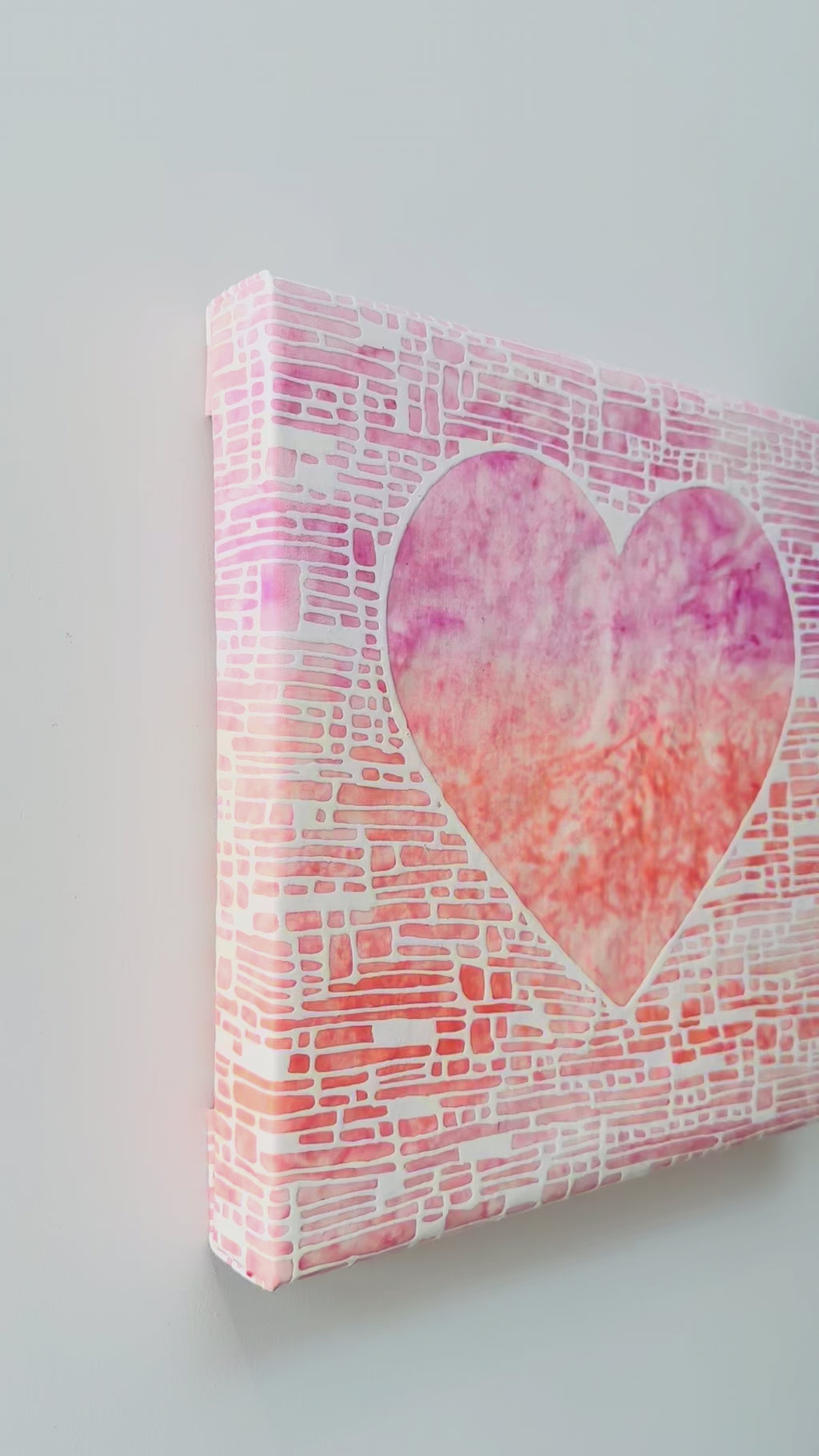 Heart shaped artwork with a white, pink, and orange gradient